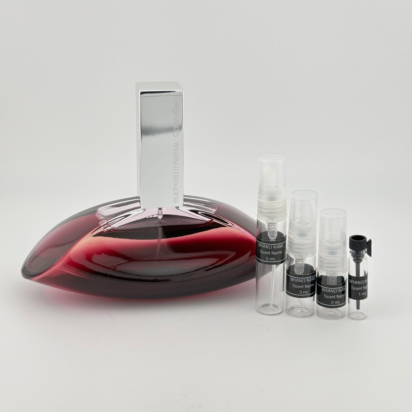Red wine decanter with small bottles on a white background